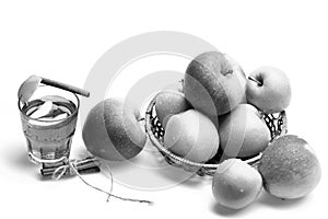 Set of fruit placed in wicker bowl near hot tea