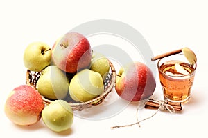 Set of fruit placed in wicker bowl near hot tea