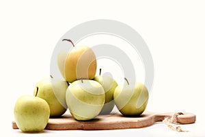 Set of fruit placed in wooden cutting board, close up.