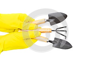 Set of garden hand tools in gloved hands isolated on white