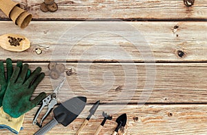 A set of gardening tools on a wooden table.