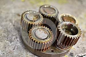 A set of gears on a steel workbench