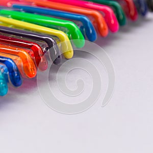 Set of gel pens of various colors with lilac background