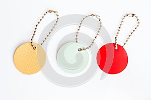 Set of genuine leather circle tags on white background