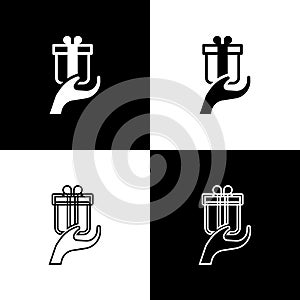 Set Give gift icon isolated on black and white background. Gift in hand. The concept of giving and receiving a gift