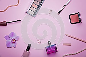 Set of glamorous woman accessories and cosmetics on the pink background.