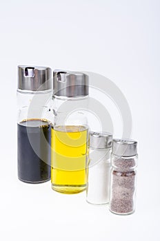 Set of glass bottles with olive oil, vinegar, salt and pepper for table setting