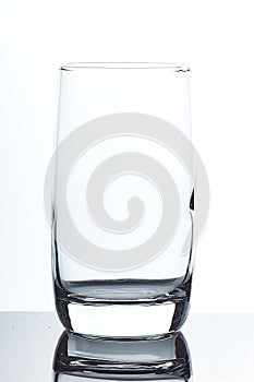 Set of glass empty glasses and goblets on a gray-white background