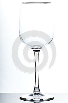 Set of glass empty glasses and goblets on a gray-white background