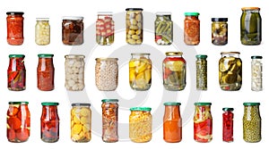 Set of glass jars with different pickled vegetables on background