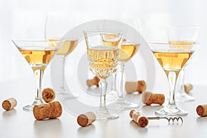 Set of glasses of yellow wine at wine tasting on white wooden table