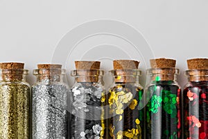 Set of glitters in bottles over white background