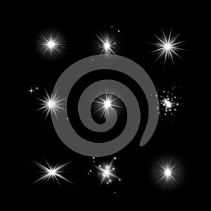 Set of glowing light effect stars. Bursts with sparkles on dark transparent background. Transparent vector stars isolated on dark photo