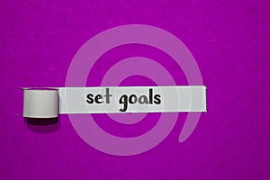 Set goals, Inspiration, Motivation and business concept on purple torn paper