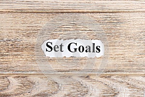 Set goals text on paper. Word Set goals on torn paper. Concept Image