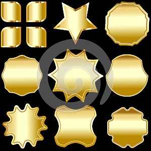 A set of gold framed badges, labels and shields, isolated on black.