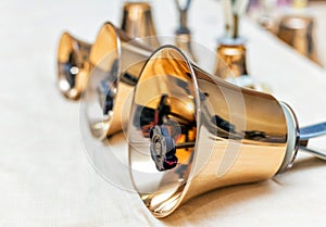 Set of gold handbells on table during concert
