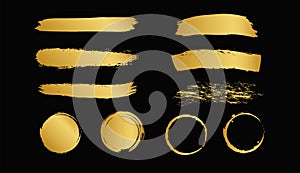 Set of gold paint brush strokes isolated on black background. Vector