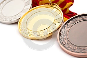 Set of gold silver and bronze award medals on white photo