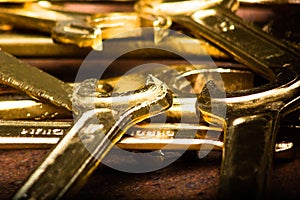 Set of golden wrenches on rusty background