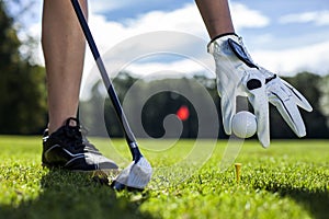 Set golf ball on a peg on field