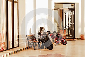 Set of golf clubs and equipment awaiting in front hotel or golf club for lifestyle design. Sport leisure lifestyle