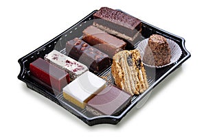 A set of gourmet cakes and desserts packaged for takeaway. Takeaway food. Isolated on a white background
