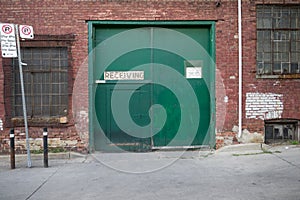 The green doors of a warehouse building
