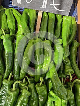 Set of green peppers with a poster