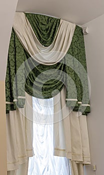 set of green and white curtains with an attached valance and tiebacks. Interior