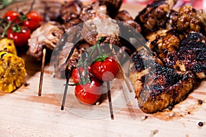 Set of grilled meat on wooden board