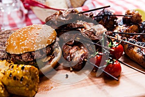 Set of grilled meat on wooden board