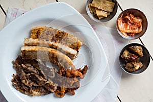 A set of grilled pork belly and marinated thinly sliced beef
