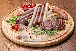 Set of grilled sausages on slate plate