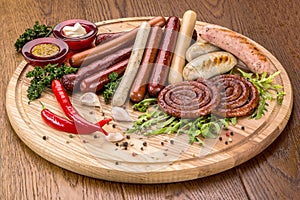 Set of grilled sausages on slate plate