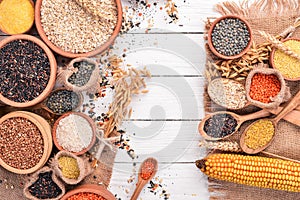 Set of Groats and Grains. Buckwheat, lentils, rice, millet, barley, corn, black rice. On a white wooden background.