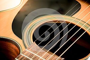 Set of guitar strings and soundhole from acoustic guitar