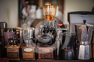 A set of hand-cranked coffee grinders and a Moka coffee pot photo