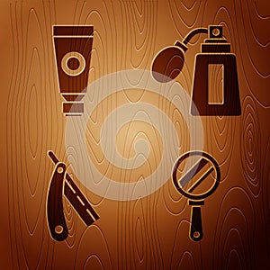 Set Hand mirror, Cream or lotion cosmetic tube, Straight razor and Aftershave bottle with atomizer on wooden background