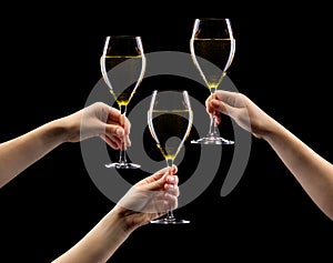 Set of hands holding white wine glass isolated on black