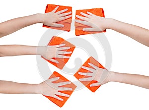 Set of hands with orange microfibre rags isolated
