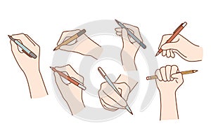 Set of hands with pens or pencils writing