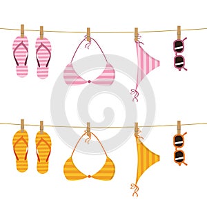 Set of hanging flip flop bikini and sunglasses on a rope