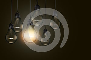 Set of hanging realistic bulbs on dark background