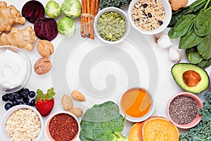 Healthy super food ingredients. Top down view frame on a white marble background. Copy space.