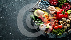 Set of healthy food in a wooden box: vegetables, fruits, fish, meat, nuts and herbs.