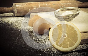 Set for home baking on a black background with flour. Rolling pi