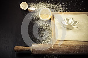 Set for home baking on a black background with flour. Rolling pi