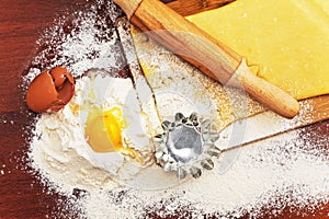 Set for home baking on a brown background with flour