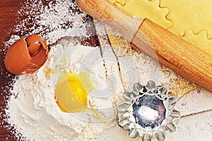 Set for home baking on a brown background with flour